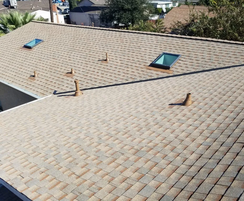 A well-installed shingled roof with skylights and vent pipes by PRI-Premiere Roofing Inc. in Livermore.